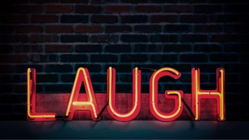 Neon laugh sign for Laughs at Lakeview comedy